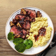 Sliced Medium Rare Steak with Mashed Potatoes and Broccoli