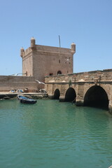 Fishing Boats and Seaside Fortress in Essaouira, Morocco
