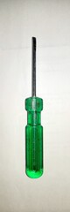 A screwdriver with green handle used for different screw tightening work