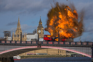 LONDON, UK -  7 2016.  A dramatic scene unfolds as a red double-decker bus explodes on Lambeth Bridge, with the iconic Parliament buildings in the background. 