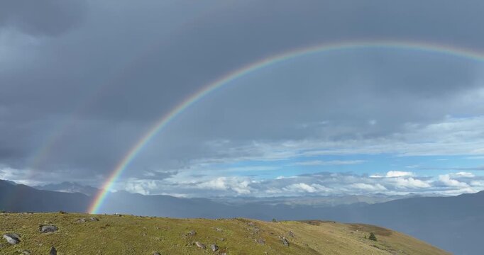 Beautiful  double rainbow after the rain on high altitude mountain top