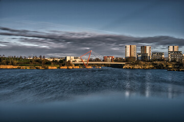 Red Suspension Bridge Over Pae Lake at Sunset with Long Exposure Water Effect