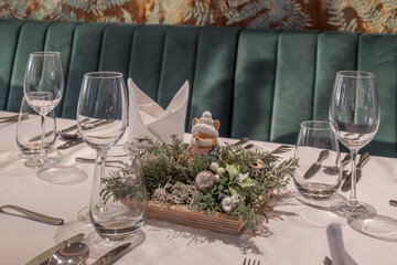 Christmas table centerpiece with fox figurine and glassware
