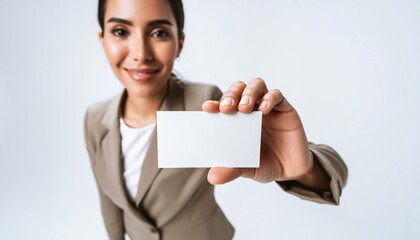 Confident professional holding blank business card for mockup in studio setting