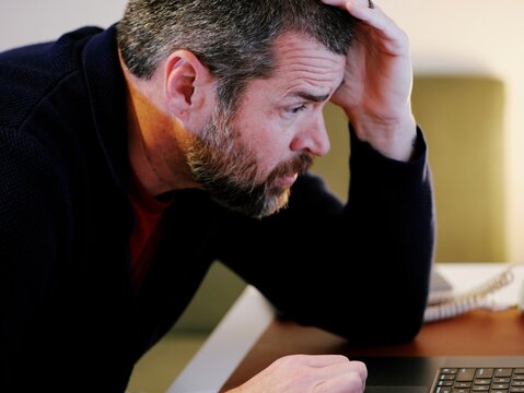 Middle Aged Executive Working From Home Falls Victim to ClickFix Captcha Black Hat Cybersecurity Attack - Educational Ransomware Hack Concept