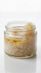 Body scrub in clear glass container with natural ingredients  