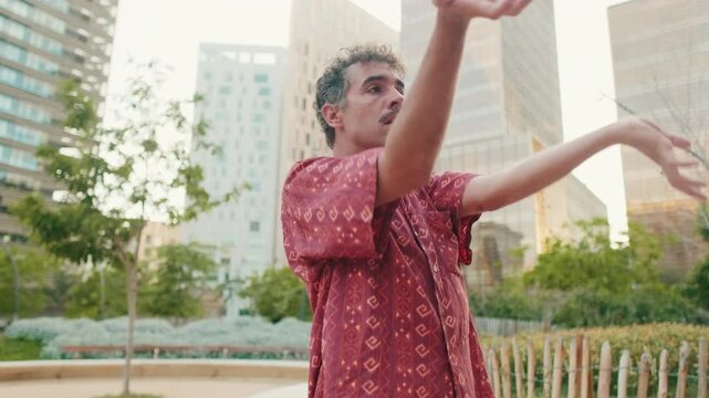 Young Man Dancing in a City Park