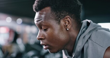 Fitness, sweaty and black man breathing in gym to recover, training exhaustion or finish exercise. Tired, workout complete and athlete with intense challenge for fatigue, relax or bokeh for wellness - Powered by Adobe