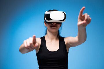 Woman using VR headset with extended arms while exploring dynamic virtual interface interaction