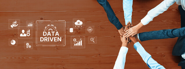 Aerial view of diverse hands coming together in teamwork to emphasize data-driven strategies....