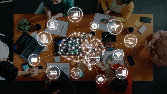 A dynamic brainstorming session shows a group of professionals collaborating around a wooden table, exploring technology-driven solutions and innovative strategies. Raster