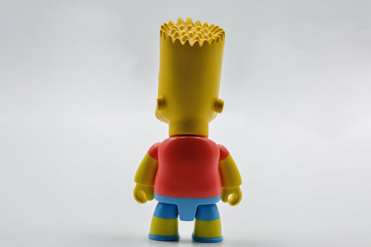 Bart Simpson toy figure closeup from behind on white background.