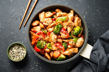 Chicken stir fry with vegetables and sesame.