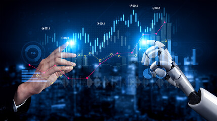 A human hand and a robotic hand interact with digital data visualizations, representing the synergy...