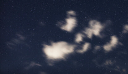 Night sky and stars with clouds passing by