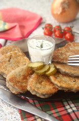 breakfast with fried potatoes draniki, tomatoes and sauce