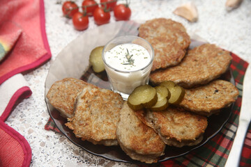 breakfast with fried potatoes pancakes draniki and tomatoes