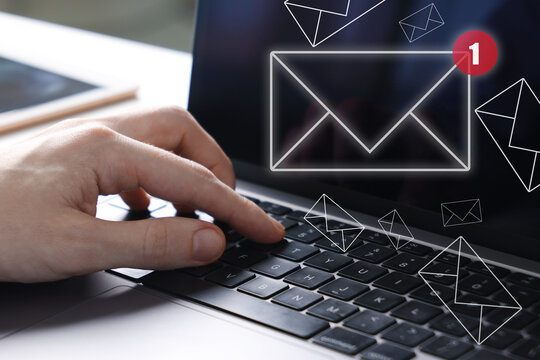 New email notification. Man using laptop, closeup. Letters flying out of screen