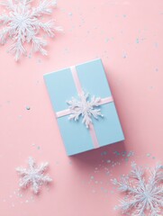 Elegant winter gift box on pastel pink background with snowflake decorations for holiday celebration