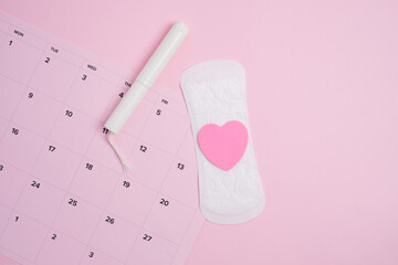 Menstrual cycle tracking calendar with sanitary products and  pink heart 