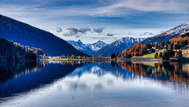 Davos. Mountain Lake Serenity, Peaceful Alpine Reflecting Snow Peaks, Calm Alpine Water Mirror Showcasing Snowy Mountain Silhouettes And Clear Skies