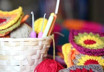 Crochet granny square, clews and hook in the basket cozy photo	