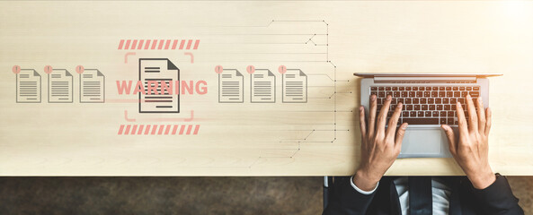 A digital workspace with a warning alert highlighted over documents illustrates the importance of accurate data management and communication in a modern office environment. Gantry