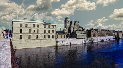 Panorama of old buildings in a row next to the Grand River in Galt, Ontario