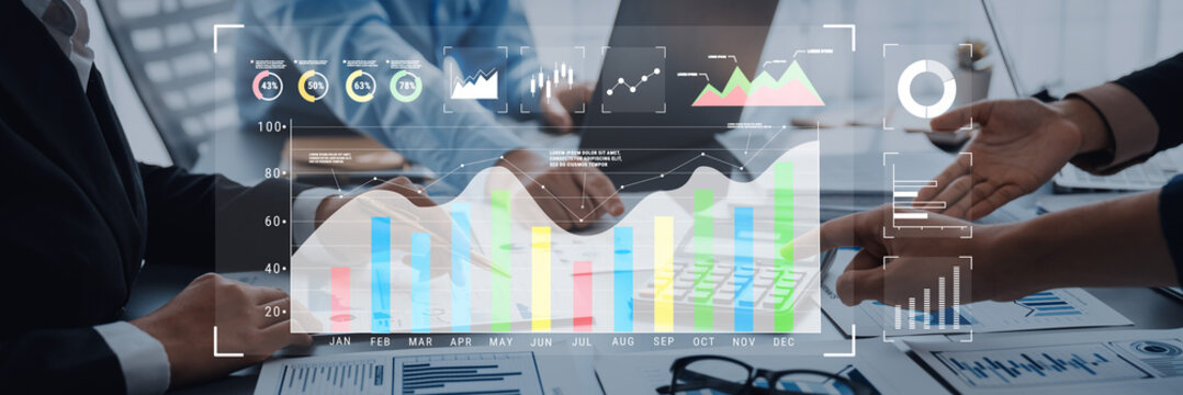 A business team engages in a financial data analysis session, showcasing graphs and charts on a digital screen, emphasizing teamwork and strategic planning in a modern office environment. Trope