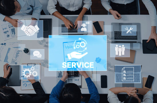 A business team collaborates in a modern office, focusing on service solutions, analytics, and digital tools to enhance teamwork and customer support efforts. Trope - Powered by Adobe