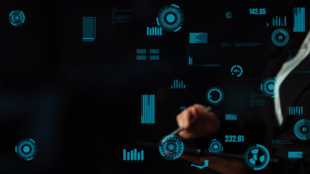 An individual interacts with a digital tablet showcasing vibrant graphs and data in a sleek interface, highlighting modern technology and information systems. Xenic