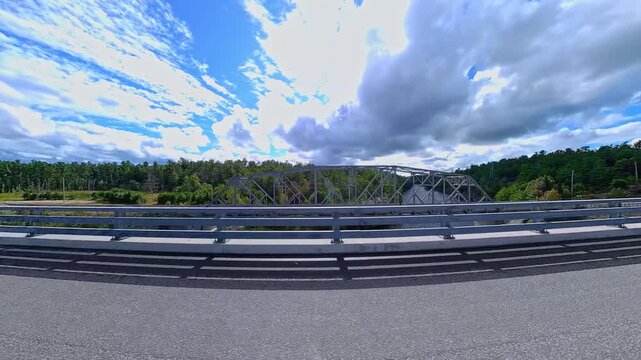 Scenic driving on Highway 6. Rocky nature mountain landscape side view road driving plate. Green forest and Canadian Shield in summer. Driving car POV side forward on asphalt road, Manitoulin Island.