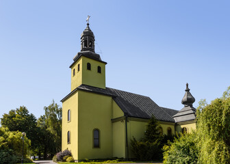 Green Village Church Surrounded by Trees Under Blue Sky. Roman Catholic Church in Modliszewko, Gniezno Commune, Greater Poland Voivodeship, Poland