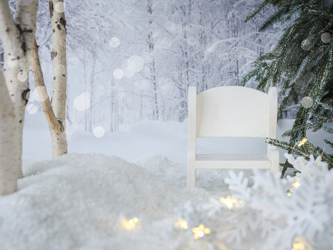 White winter season scenery background in field snow with wood cozy bench, birch and pine trees, snowflakes, twinkle fairy lights, blurry backdrop trees and bokeh. Christmas card to customIze.