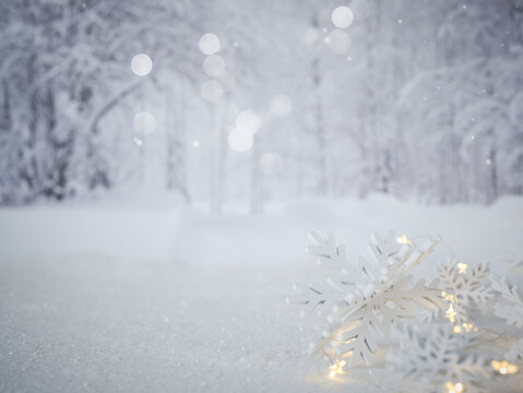 White winter season scenery background with field of snow, snowflakes, twinkle fairy lights, blurry backdrop trees and bokeh. Christmas card to personalize.