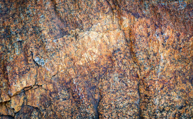 Natural rough stone texture with orange and brown mineral surface