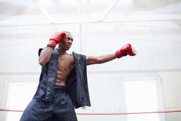 Athlete, black man and gloves for fight in boxing ring for fitness, strength training and battle...