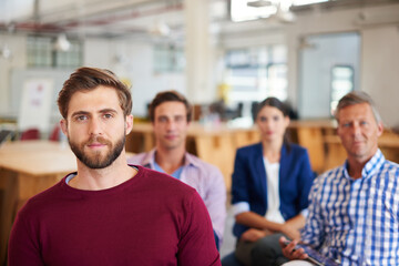 Obraz premium Man, listening or presentation with team in workshop for staff training, trade show or seminar. Portrait, male person or business people in career convention for company growth, conference or meeting