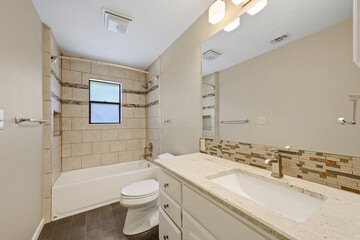A wellequipped bathroom featuring a toilet, sink, and a bathtub