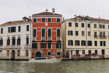 Water taxi passing historic buildings in Venice, Italy