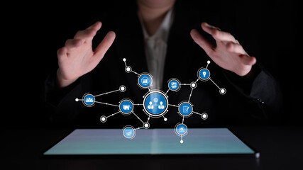 A professional hands hover over a glowing display, manipulating holographic icons that symbolize digital networks, data interaction, and modern technology. Tessel