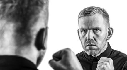 Man Confronting His Reflection with Clenched Fists, Black and White Portrait of Strength