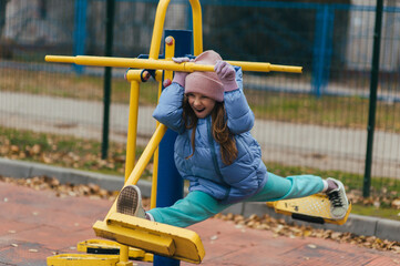 A beautiful, strong teenage girl is involved in sports, fitness on exercise machines, training...