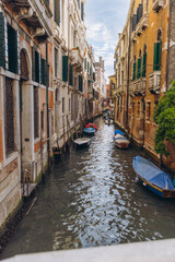Venice canal with historical buildings and moored boats