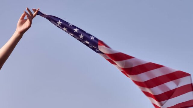 A U.S. flag waves against a clear sky, symbolizing American freedom and patriotism. It's perfect for celebrating Constitution Day and national pride