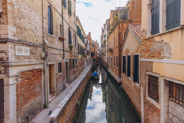 Venice canal with old historic crumbling buildings and boat © anatoliycherkas