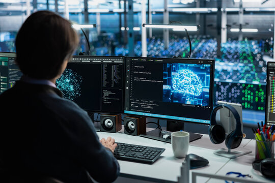 Data center engineer using PC, adjusting AI model parameters to enhance accuracy. Server hub worker scheduling artificial intelligence ran maintenance for hardware components