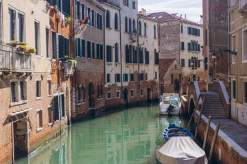 Venice canal with old buildings and boats