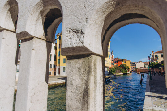 Stone arch framing a Venice canal cityscape