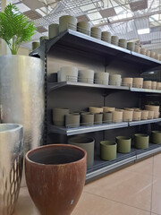 Fototapeta premium Ceramic flower pots on supermarket shelves. Ceramic products in flower shop